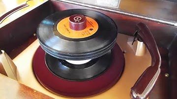 VM record player playing a stack of 45 RPM records
