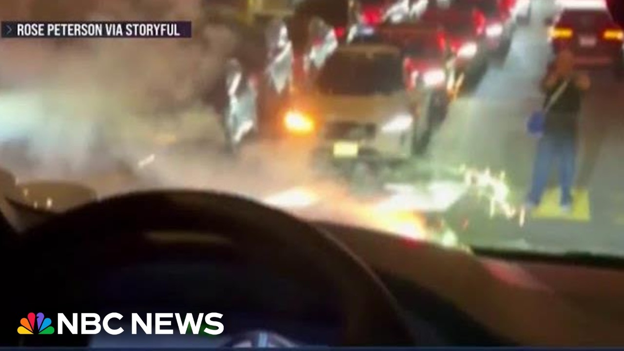 Waymo car travels over lit firework as other cars run out of battery in holiday gridlock