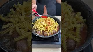 Creamy pasta with meatballs in a pot