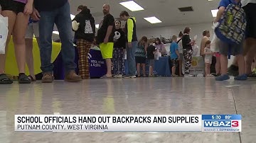 Putnam County School volunteers hand out backpacks and supplies