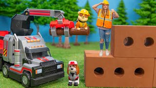 assistant helps to build the paw patrol big truck stop with als truck