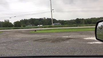 Repairing a gravel parking lot with a compact tractor and box blade