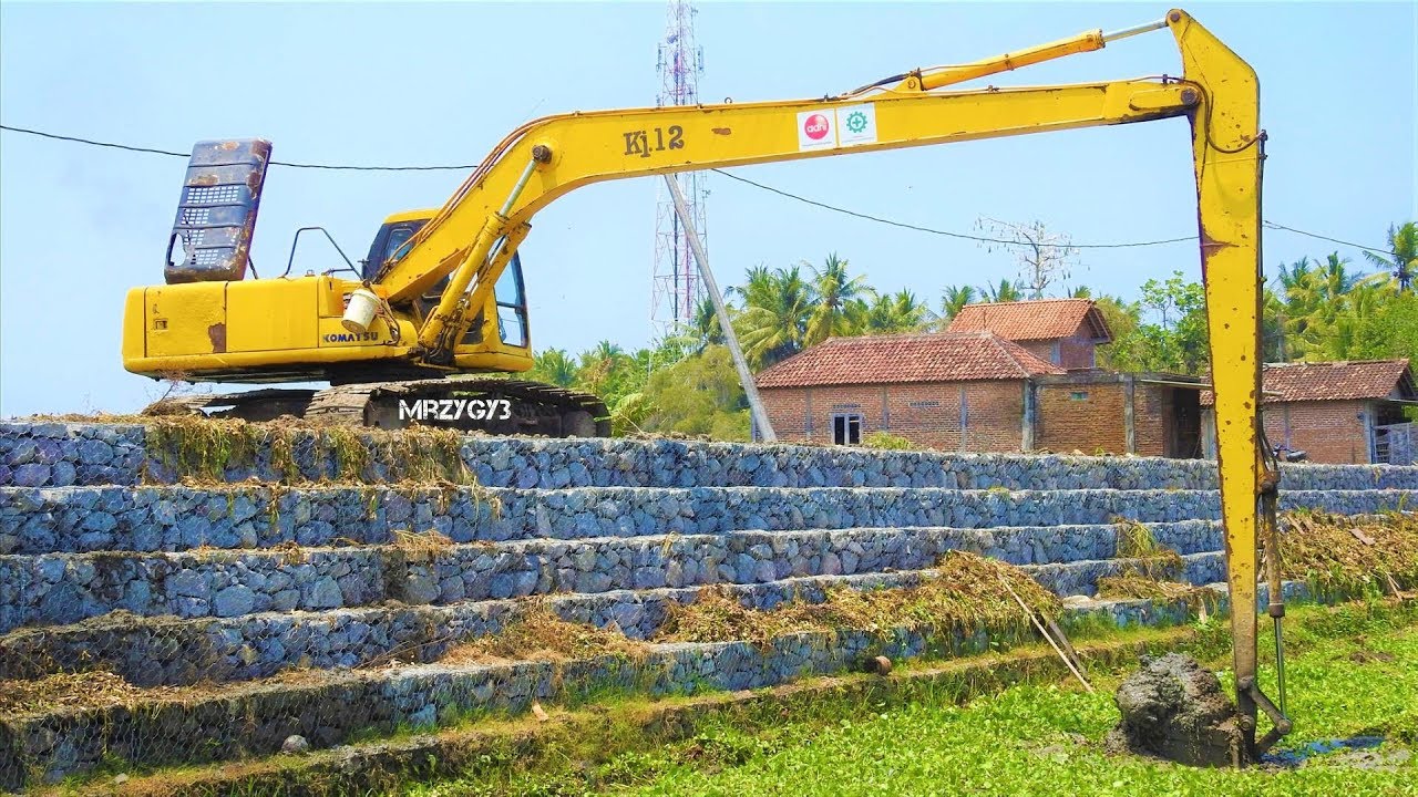 Long Reach Excavator Excavating Sedimentation Of Mud From The River ...