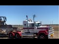 Big V8 Mack hauling dozer