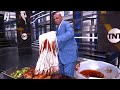 Chuck putting BBQ sauce on chicken using a mop 😂