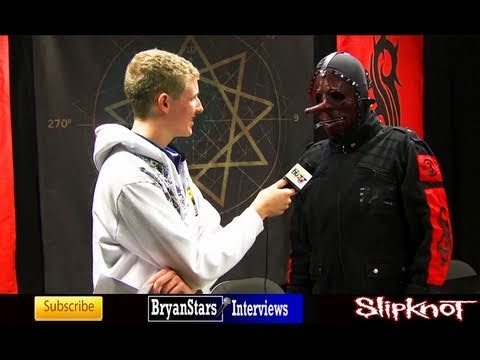 Check out my backstage interview with Slipknot's #3 Chris Fehn Slipknot is a heavy metal band from Des Moines, Iowa. After a number of lineup changes and difficulties early on, the current lineup of Slipknot finally released their self titled debut album in 1999 under Roadrunner Records. The record was a surprise smash, instantly putting Slipknot on the map of heavy metal music. Featuring the hit singles Wait and Bleed and Spit It Out, it went on to be certified double platinum and is still to date the band's best selling album. Slipknot's bizarre image and crazy on stage antics soon earned the band a huge following. And with such a large fanbase, expectations were high for their follow up record Iowa, named after their home state. But after months of hard work, Iowa lived up to expectations and took the band's status from underground legends to mainstream superstars. Landing at #3 on the Billboard Charts, Rolling Stone called Iowa "the first great record of the nu metal era." Fans agreed, praising Slipknot and their break from the norm of popular music. Even the Grammy's took notice of the band, nominating the song Left Behind for a Grammy. After several more headlining tours in front of their crazed, obsesed fans, Slipknot wentback into the studio to record their third album in 2003. And while the band had already been nominated for Grammys, sold millions of records and toured to hundreds of thousands, there was still one obstacle left in their way. Despite all of their <b>...</b>