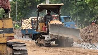 Witness The Power Of Bulldozers As They Push Dump Trucks Unloading Rock For Road Construction!
