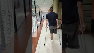 Amputee guy walking around with crutches