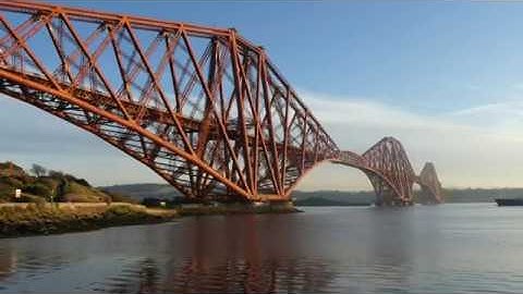 Autumn Cargo Ship Passing Under Forth Railway Bridge Firth Of Forth Scotland