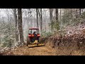 More Kubota M6060 digging a road in a steep hillside!