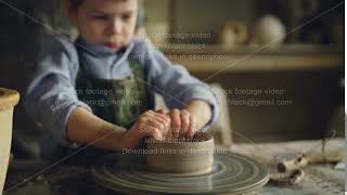 Serious Boy Is Forming Pot From Clay On Throwing Wheel While Attending Pottery Cl In Childrens