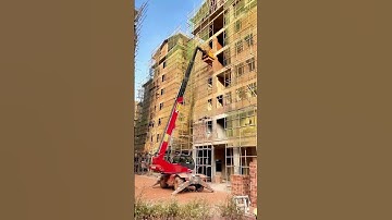 In High-Rise Construction, Crane Efficiently Transports Red Bricks!