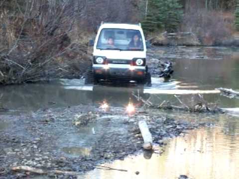 7 Year old driving a Suzuki Carry with MAttracks thru creek. Samurai Trucks is the leading importer track conversion specialists of Japaenese Mini Trucks. ww...