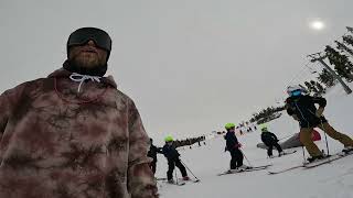 Skier rides down slope then grinds rail and crashes into little boy on skis