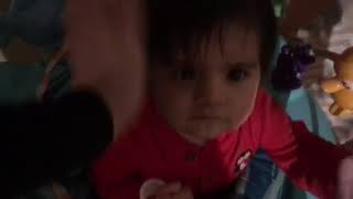 Woman throws cheese at baby seated in bouncer
