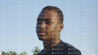 Young African American Man Looking At Camera As It Moves Around Him