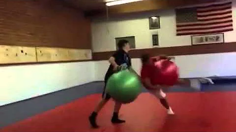 Two guys with yoga balls collide!