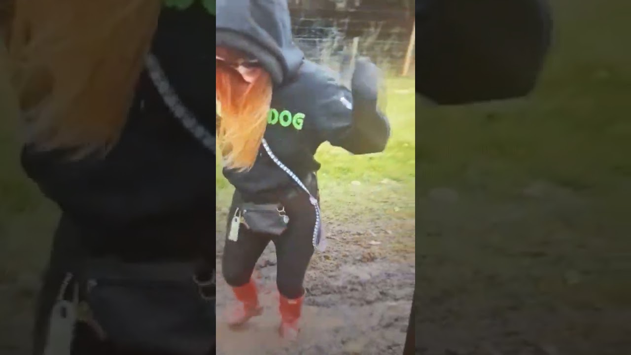 woman in red hunters in mud outdoors wading paddling sploshing leggings