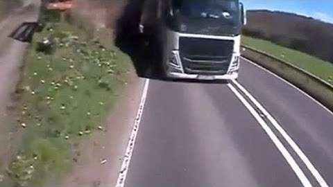 Motorist narrowly avoids a head-on smash with a speeding lorry on the WRONG side of the road