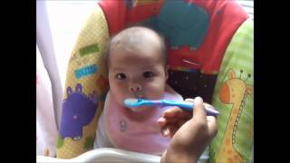 Enrique feeding Alyssa baby cereal :)