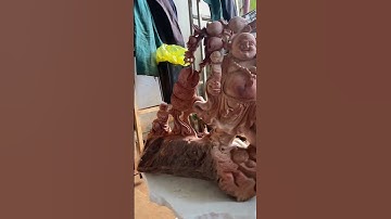 Tượng gỗ di lặc đứng vác cành đào