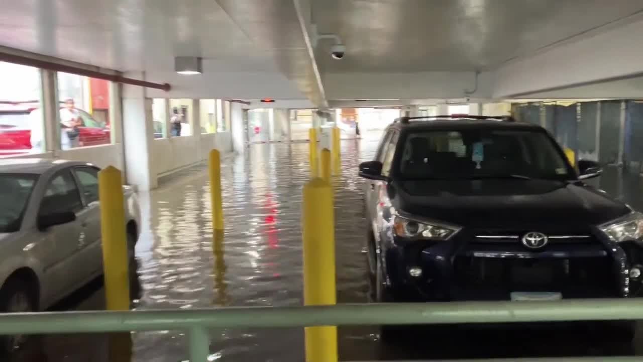 Parking garage floods in downtown Norfolk after storm - YouTube