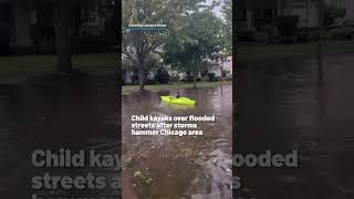 Child kayaks over flooded streets after storms hammer Chicago area