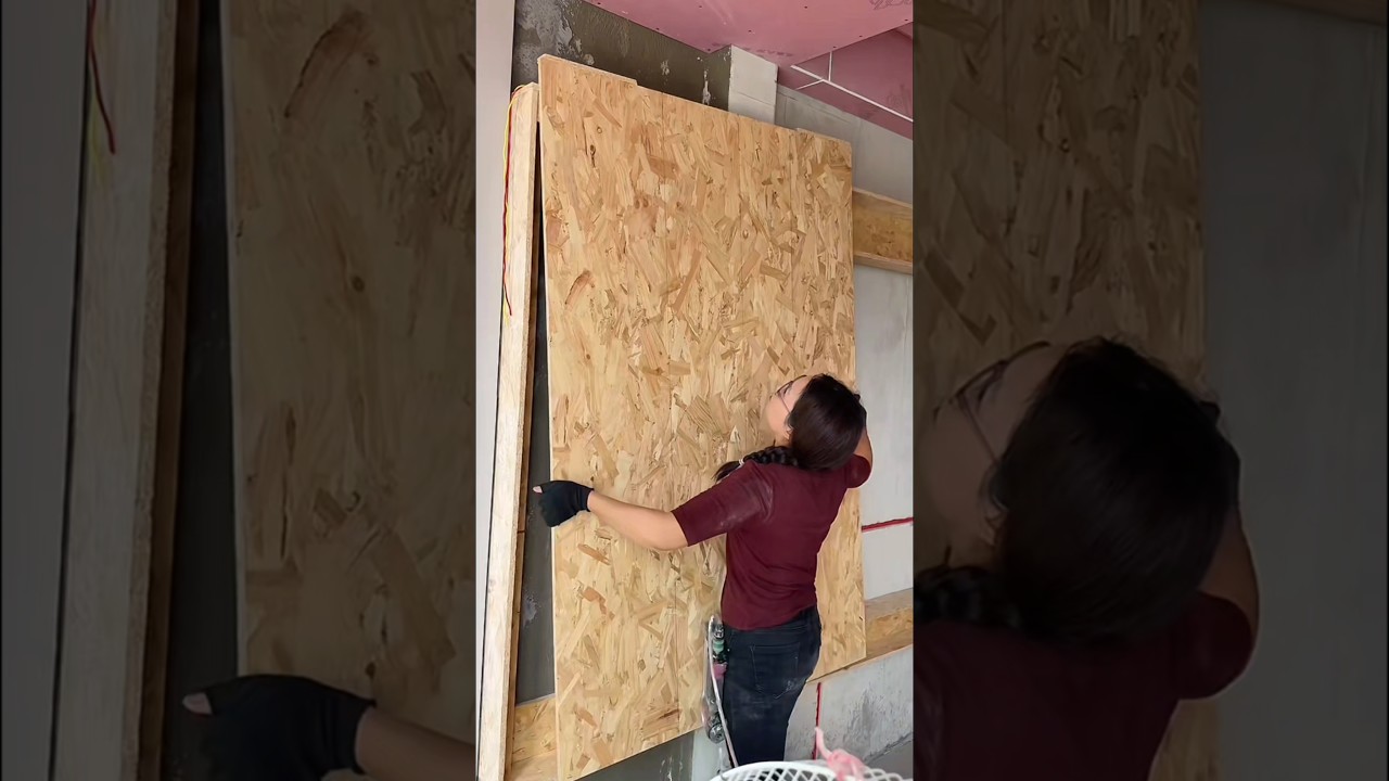 Female carpenter making TV background wall