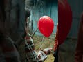 reepy smiling clown giving red balloon to teenage girl