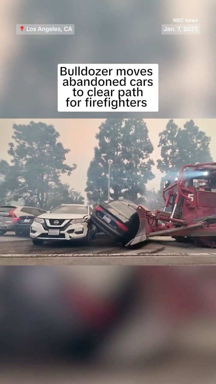 Bulldozer moves abandoned cars to clear path for firefighters