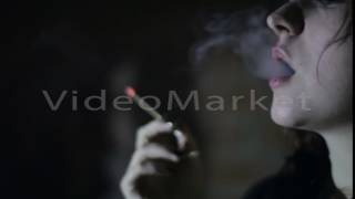 Girl smokes a cigarette close-up