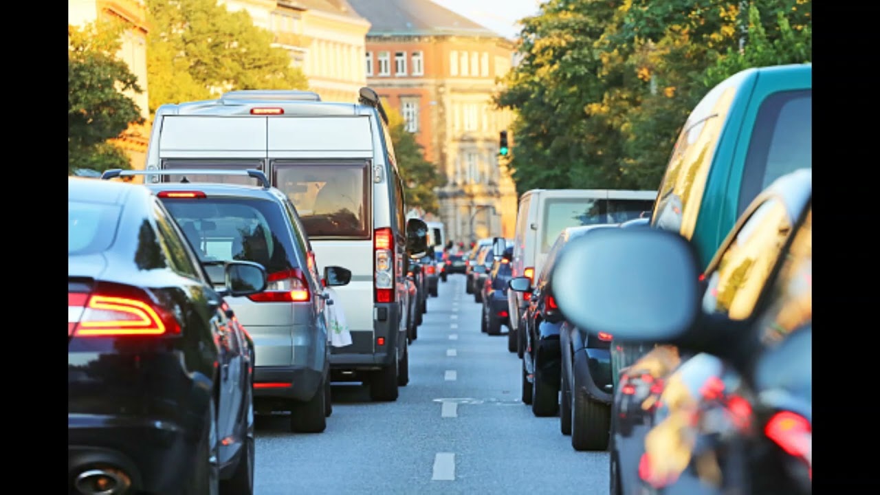 Busy traffic, cars passing, horns beeping