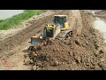 The Power Dozer Equipment Moving Building Road Hard Pushing Worker With Dump Truck Spreading