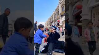 Cute Baby Giving Candy To Super Hero