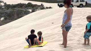 Hayden and Mason sliding down the dunes