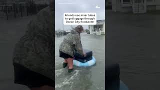 Friends use inner tubes to get luggage through Ocean City floodwater | NBC4 Washington