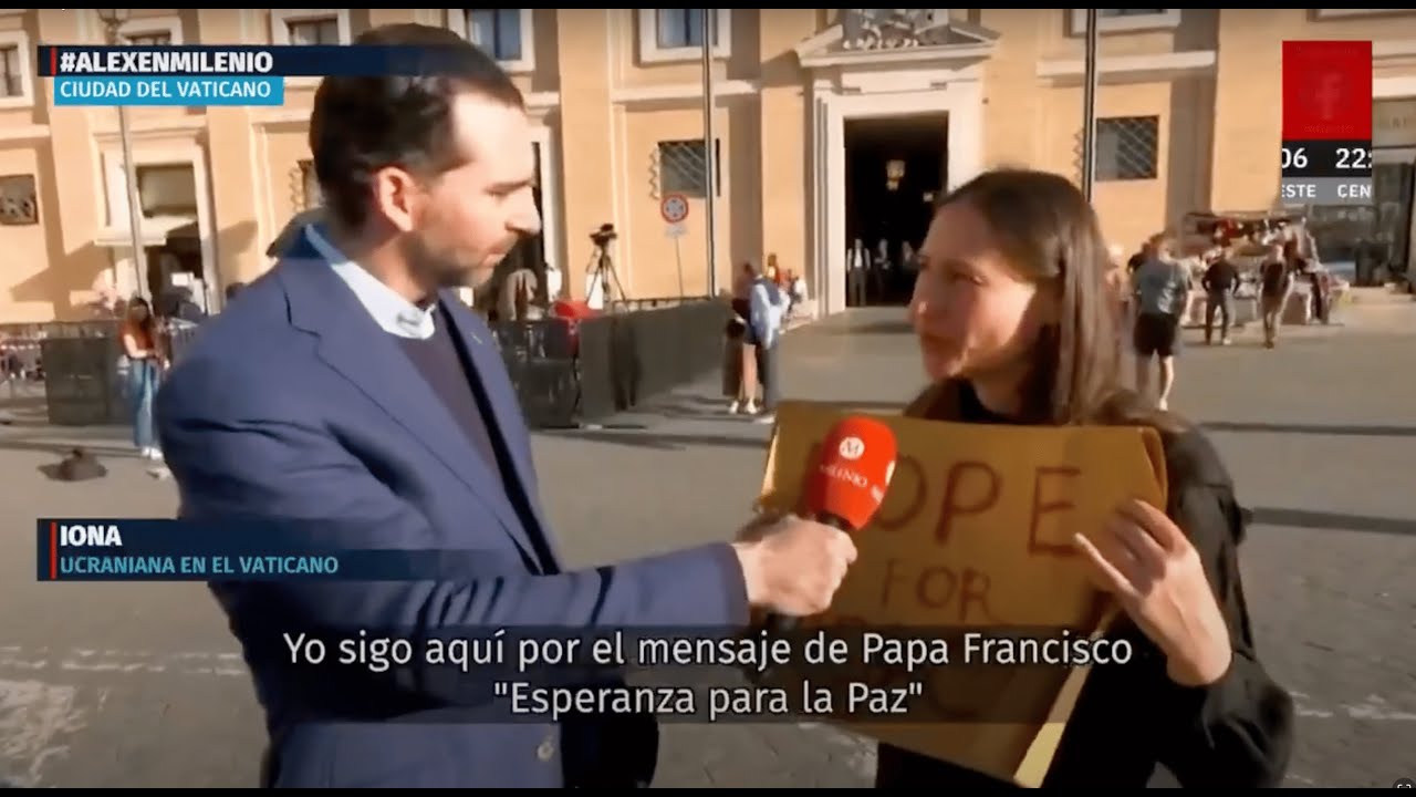 Yona Tukuser holds a "HOPE FOR PEACE" sign in St. Peter's Square at the Vatican during the Conclave
