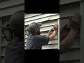 Nothing says fun like fighting vinyl siding in the rain 😅 #vinylsiding #diy #thefixer
