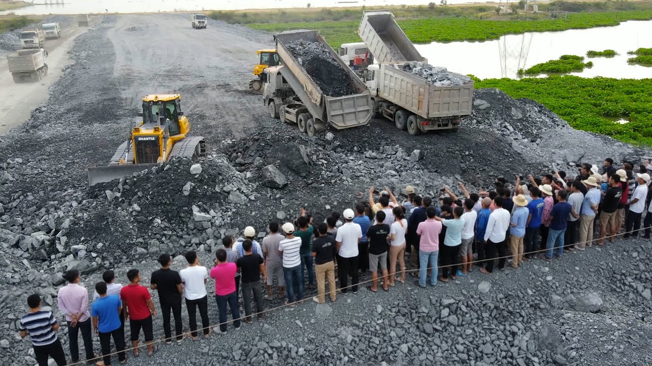 Great Take Look Action Technique with Team Operator Bulldozer and Dump Truck Moving Stone Filling Up