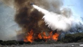 Firefighters Battle Brush Fire Below Snow Capped Mountains