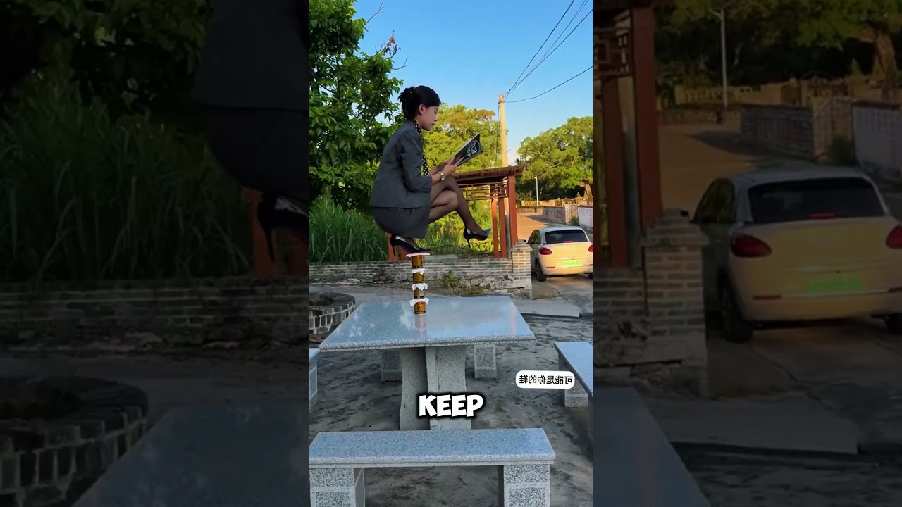 Standing on one foot in high heels on a bottle