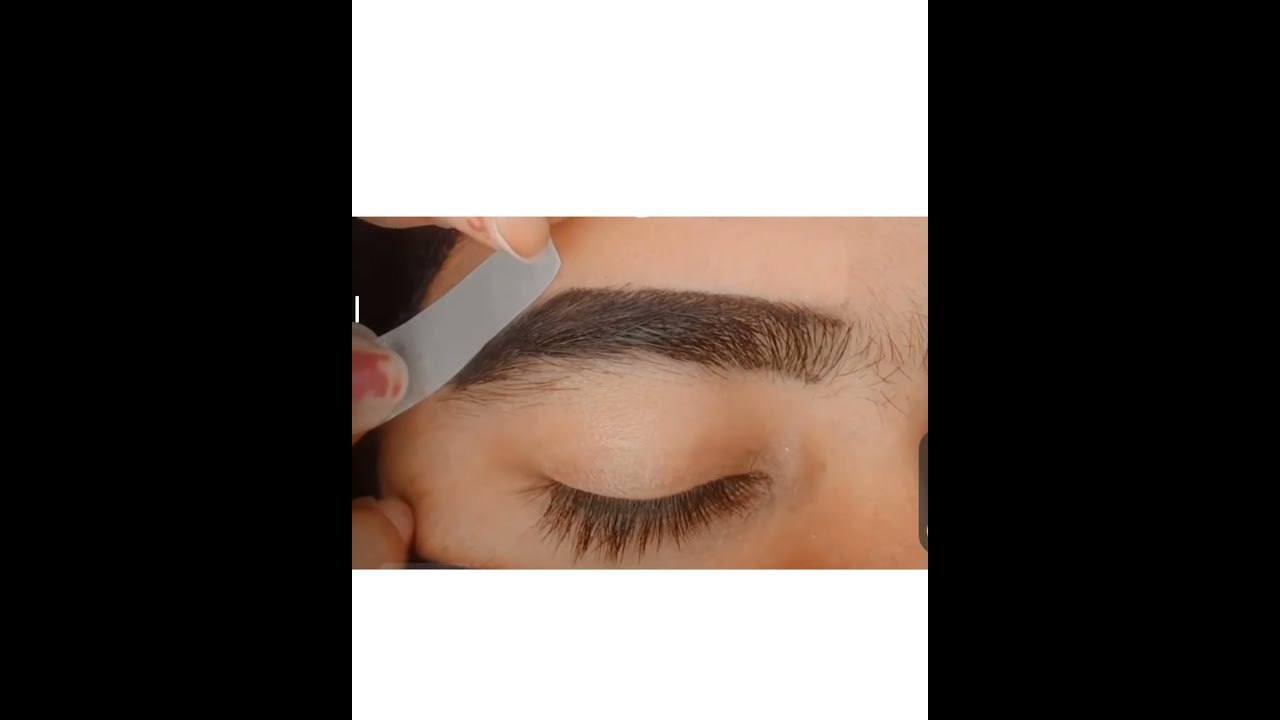 Wax strips apply in eyebrows for shaping 