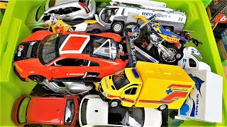 Box full of various miniature toy cars