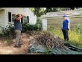 Father and Son Help Elderly Woman With Crazy Overgrown Lawn Cleanup