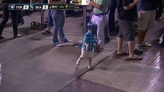 Young fan plays catch and gives high fives