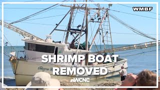 Myrtle Beach, SC crews work to remove shrimp boat washed ashore by Hurricane Ian