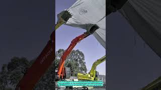 Heavy Equipment Tool Using Excavator Buckets for Lifting Shade Nets