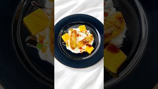 Creamy yogurt topped with caramelized banana, mango, a drizzle of dates syrup, and tutti frutti