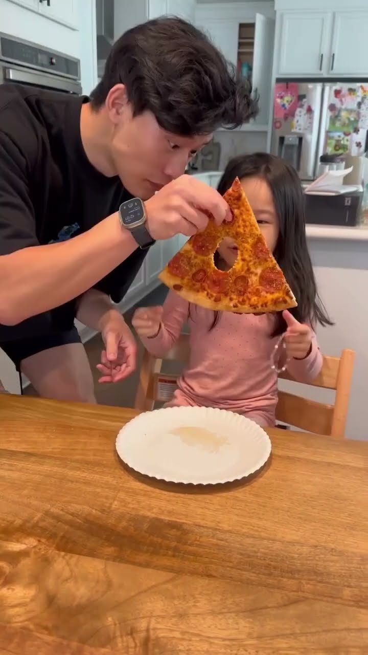 Eating a hole in her pizza to see her reaction ??