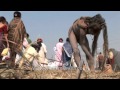 Western sadhus watch as naga sadhu applies human cremation ash on his body  kumbh mela allahabad